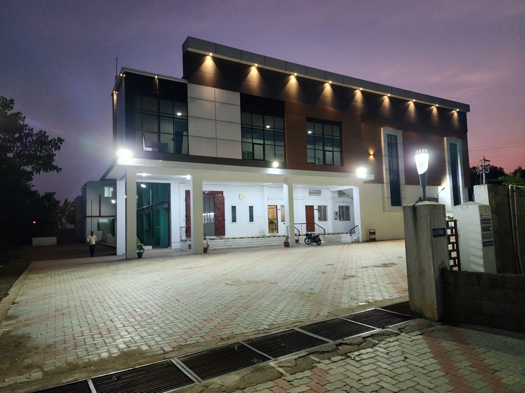Quality Knit Wears manufacturing facility illuminated at dusk